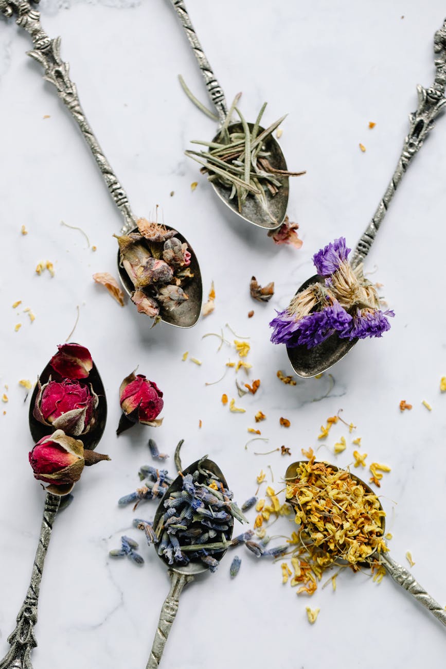 various dried flowers on teaspoons